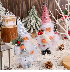 Macro detail of Santa figurines with sequins and fur, standing on a snowy scene