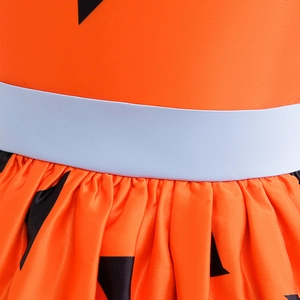 Detailed view of the orange satin dress waist with black patterns and blue belt detail