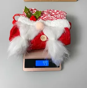 Detail of Christmas faceless gnome candy bag showing weight of 49g on digital scale