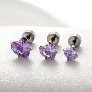 Detailed macro view of purple heart-shaped zircon earrings in three different sizes