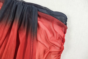 Close-up of red and black gradient mesh fabric with fine stitching for holiday sets