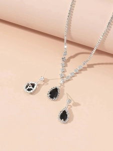 Detail of silver bridal jewelry set featuring black teardrop crystals and clear zircons