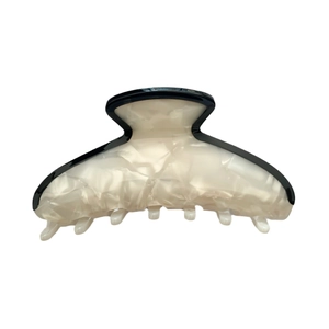 Minimalist acetate hair claw clip with cream textured finish and black trim detail