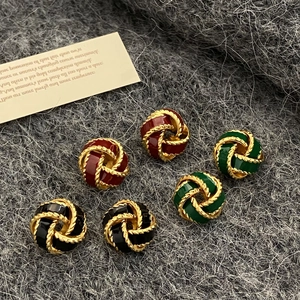 Elegant French vintage love knot earrings in red, green, and black with gold textures