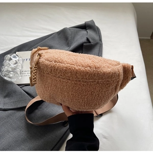Close-up of a khaki fleece fanny pack with adjustable strap on a clean background