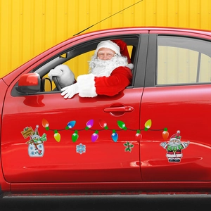 Close-up of Santa Claus and snowman magnetic car stickers on a red vehicle side