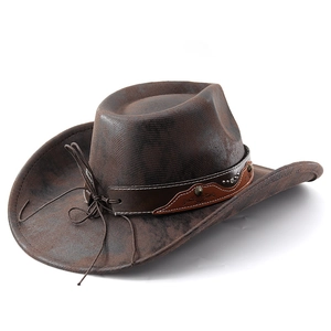 Detail of dark brown western cowboy hat with studded leather band and textured finish