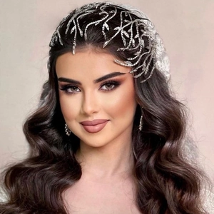 Close-up of bridal headband with intricate silver rhinestone leaf designs and crystals