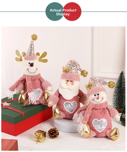Close-up of pink Christmas plush toys including Santa, reindeer, and snowman with sequins