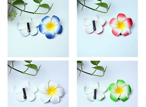 Collage of artificial frangipani hair clips in four gradient colors with back view