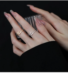 Macro detail of gold and silver plated H-shaped rings with sparkling cubic zirconia inlay