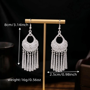 Ethnic silver tassel earrings with size and weight dimensions on a jewelry display stand
