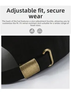 Close-up of adjustable bronze metal buckle on black twill baseball cap for custom fit