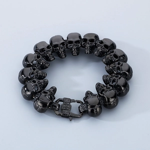 Detailed close-up of a black skull bracelet in punk style made of polished stainless steel