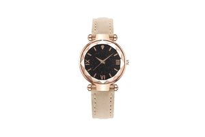 Detail of starry dial watch with faceted glass and beige leather strap on white background