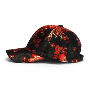 Ethnic style black cotton baseball cap with intricate red and gold floral embroidery detail