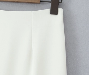 Detail shot of white twill fabric texture and clean stitching on the waistband