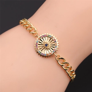 Close-up of gold plated Cuban chain bracelet with colorful zircon evil eye sun charm