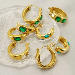 Detailed macro view of 18k gold-plated C-hoop earrings with colorful gemstones