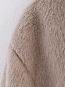 Detailed close-up of soft beige wool blend fabric texture for casual women jackets