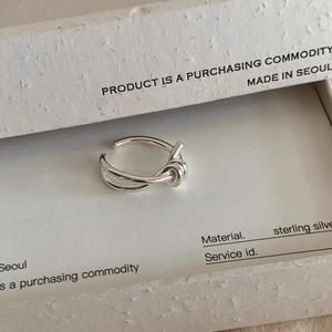 Detailed view of S925 sterling silver knotted ring with engraved silver hallmark