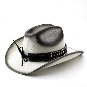 Detail of western straw hat featuring gradient black edges and silver studded leather band