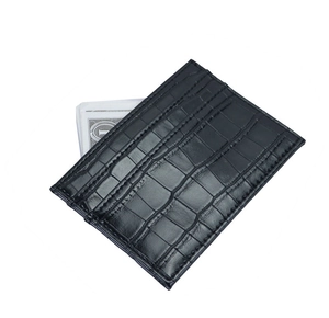 Macro view of black crocodile pattern leather wallet showing card slots and money compartment