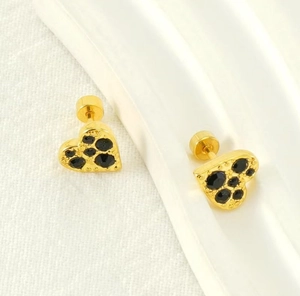 Detail of gold-plated heart earrings with black zircon stones and secure backs
