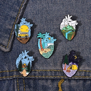 Set of five anatomical heart enamel pins featuring landscape and travel adventure themes