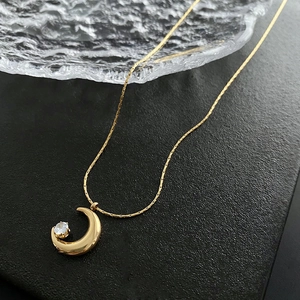 Minimalist gold moon necklace with sparkling round crystal on a sleek snake chain