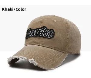 Detail of khaki distressed baseball cap featuring Purist embroidery and frayed brim
