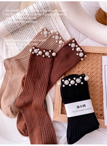 Detail of knit socks with elegant faux pearls and rhinestone petal embellishments