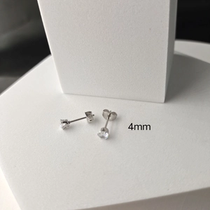 Detailed macro view of 4mm silver stainless steel stud earring with six-claw zircon setting