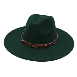 Detail of dark green wide-brim fedora hat featuring beaded band and golden feather pendant