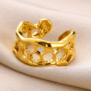 Macro shot of gold irregular heart ring featuring textured lava style and open band design