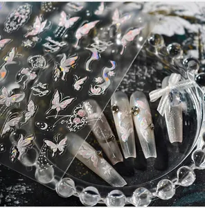Macro detail of iridescent butterfly nail stickers with star and moon patterns