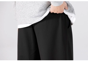Detail of men's casual straight trousers featuring side pockets and drawstring waist