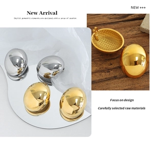 Detailed macro view of oval gold and silver polished earrings with internal mesh texture