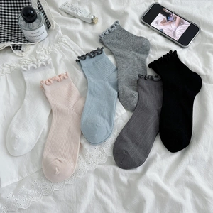 Pastel color lace trim knit crew socks set in white, pink, blue and grey on lace bedding