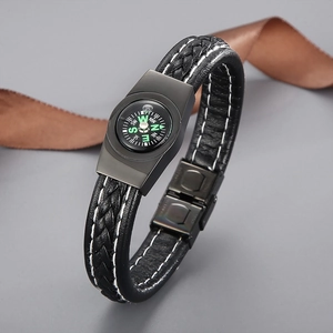 Men's braided black leather bracelet with survival compass and metal buckle on grey background