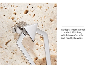 Macro view of geometric S925 sterling silver triangle stud earring with 925 certification mark