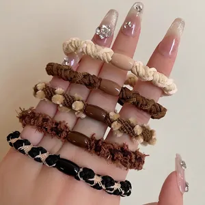 Set of 5 high-elasticity plush hair ties in milk coffee shades worn on a wrist