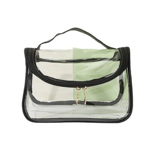 Portable transparent PVC travel toiletry bag with black trim and handle on white background