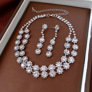 Detailed view of luxury silver flower jewelry set with sparkling rhinestones in a gift box