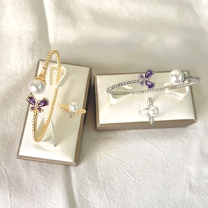 Detail of adjustable micro-pave butterfly and pearl jewelry sets in gold and silver
