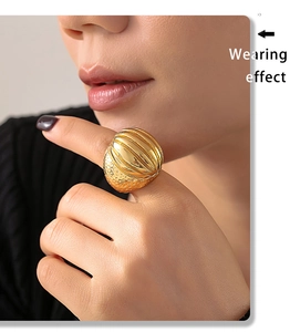 Wearing effect of vintage gold oval textured ring with vertical and hammered patterns