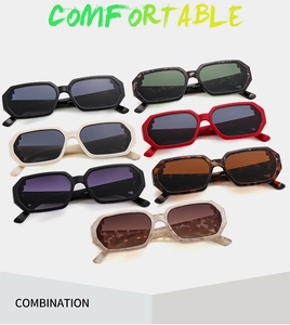 Flat lay of diverse geometric hexagonal sunglasses in multiple frame colors and tinted lenses