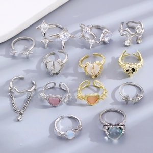 Detail shot of assorted silver and gold rings with heart, star, and gemstone accents