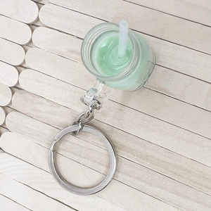 Mini bubble tea keychain with green matcha milk tea design and silver metal ring
