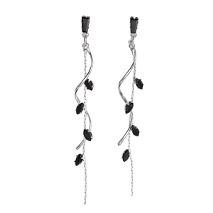 Macro shot of silver twisted tassel earrings with black marquise cut gemstones